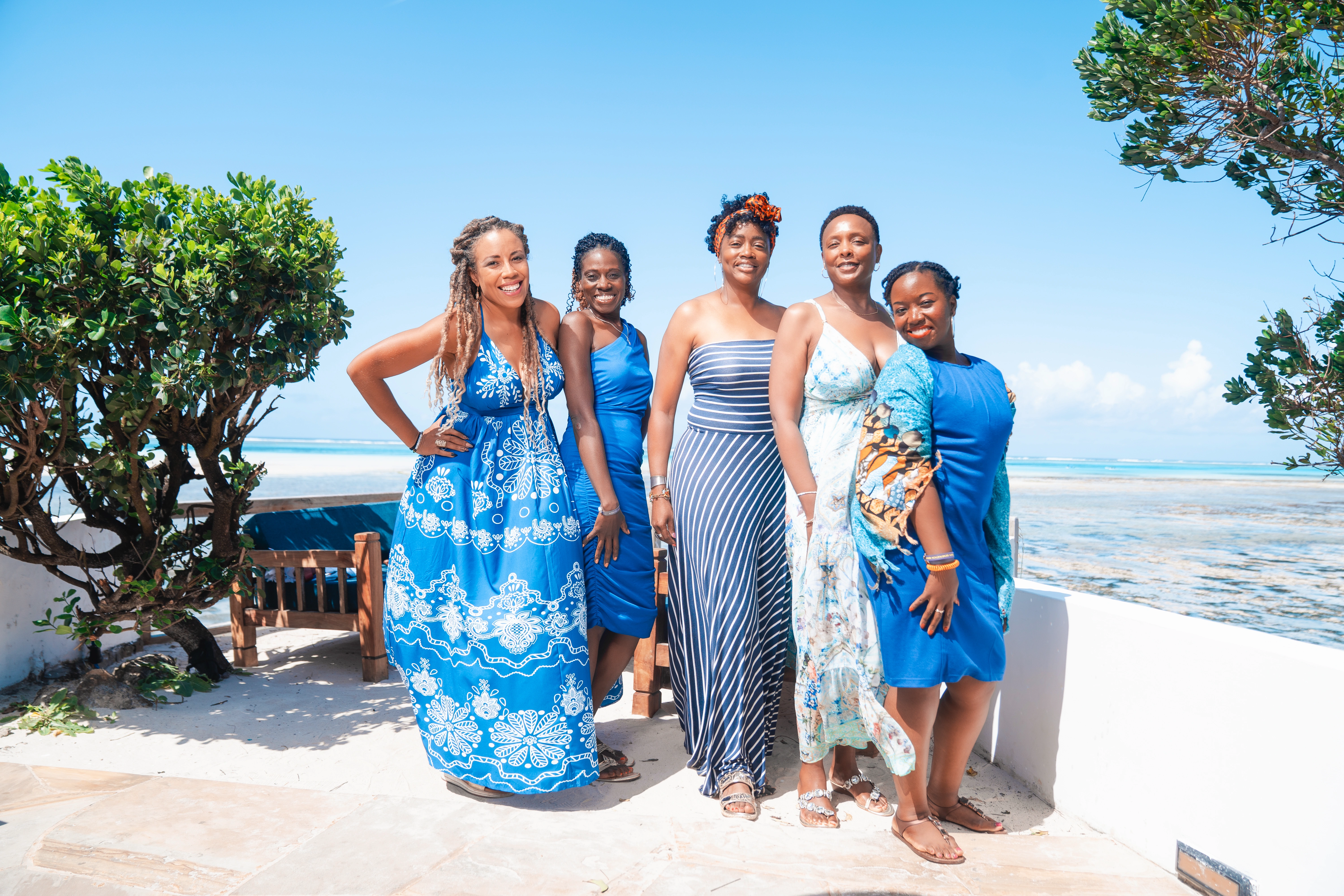 group of professional women posing on Zanzibar beach retreat