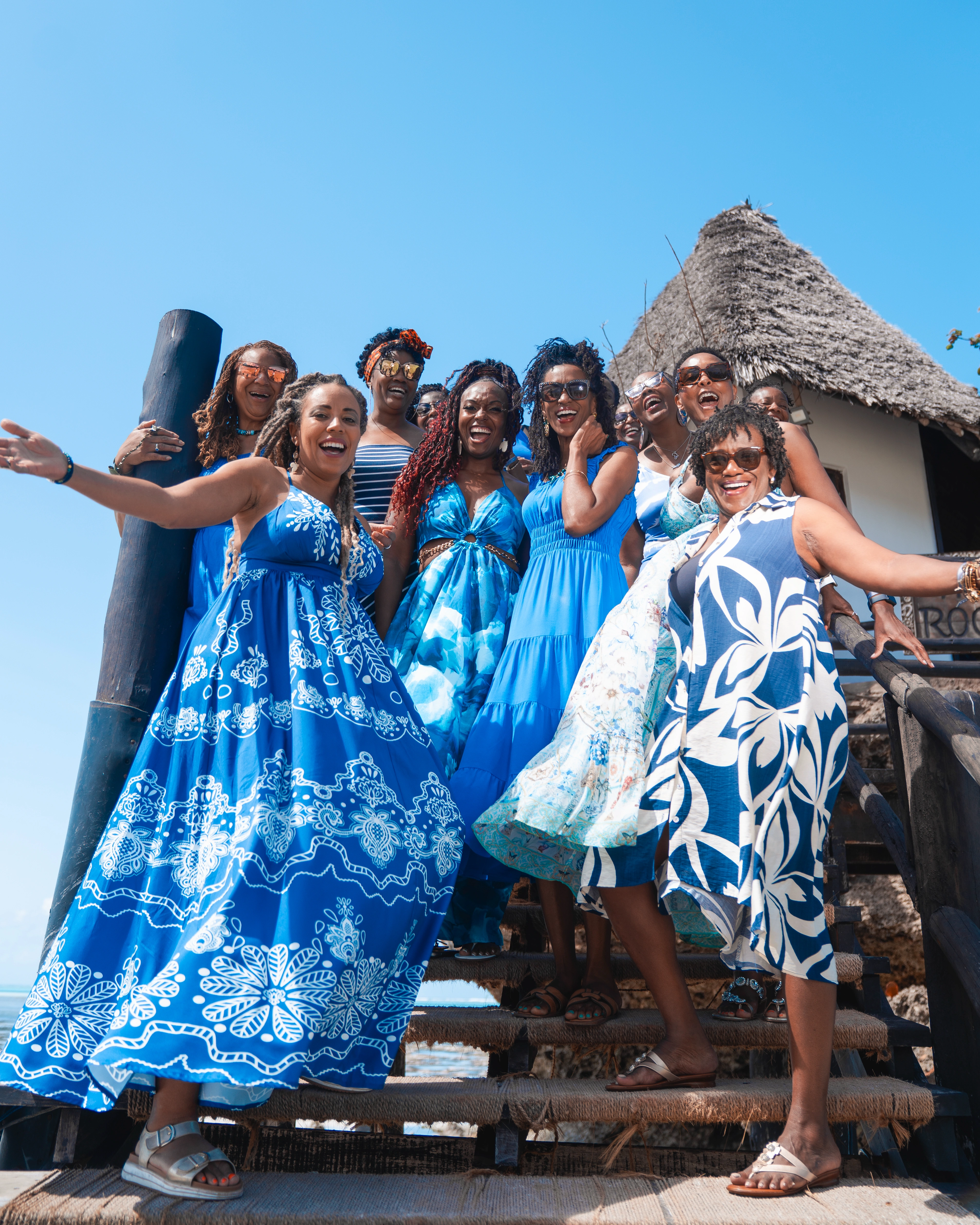 group of women in blue dresses at Zanzibar beach retreat WANTED Woman experience