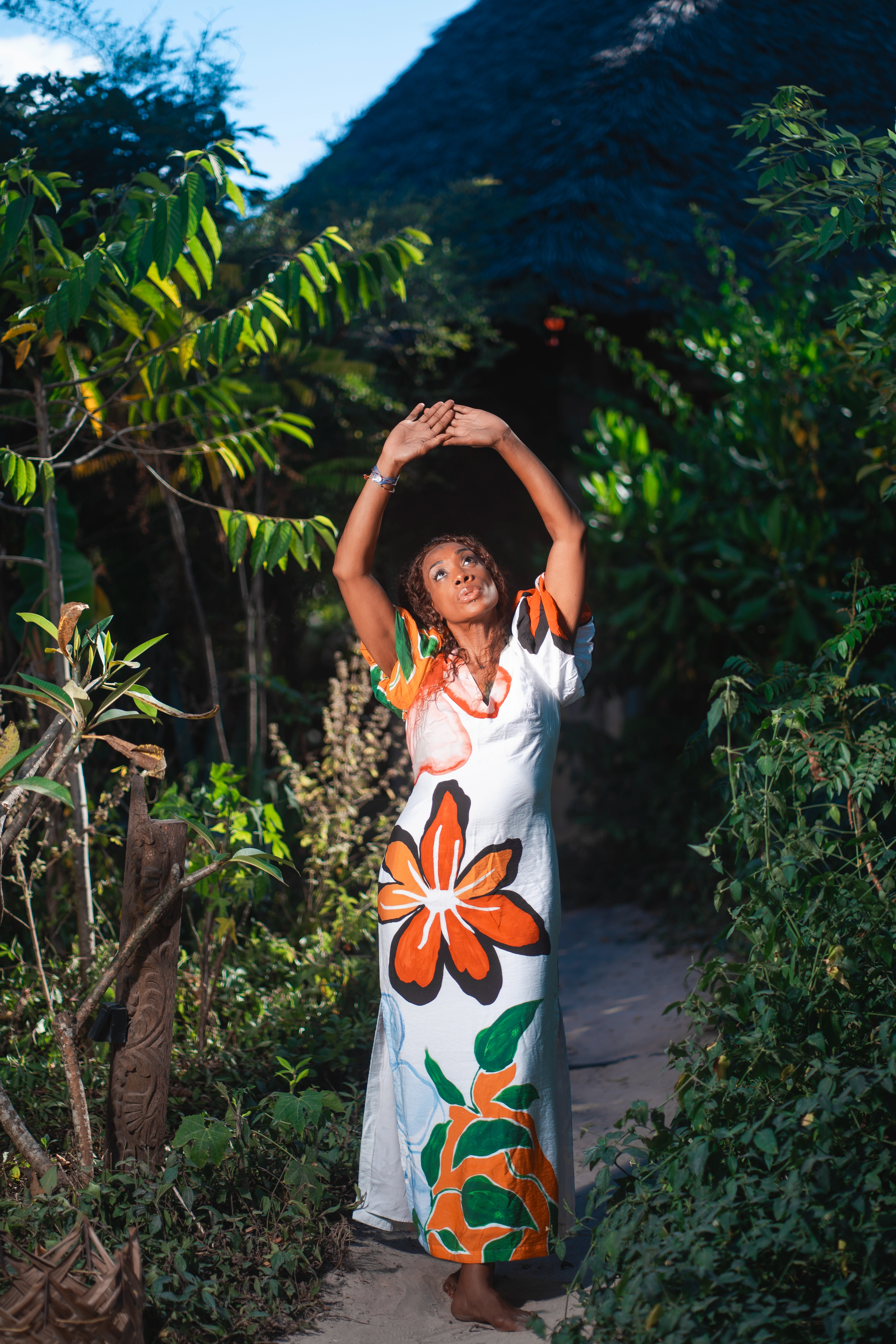 woman in colorful dress in tropical Zanzibar setting retreat experience