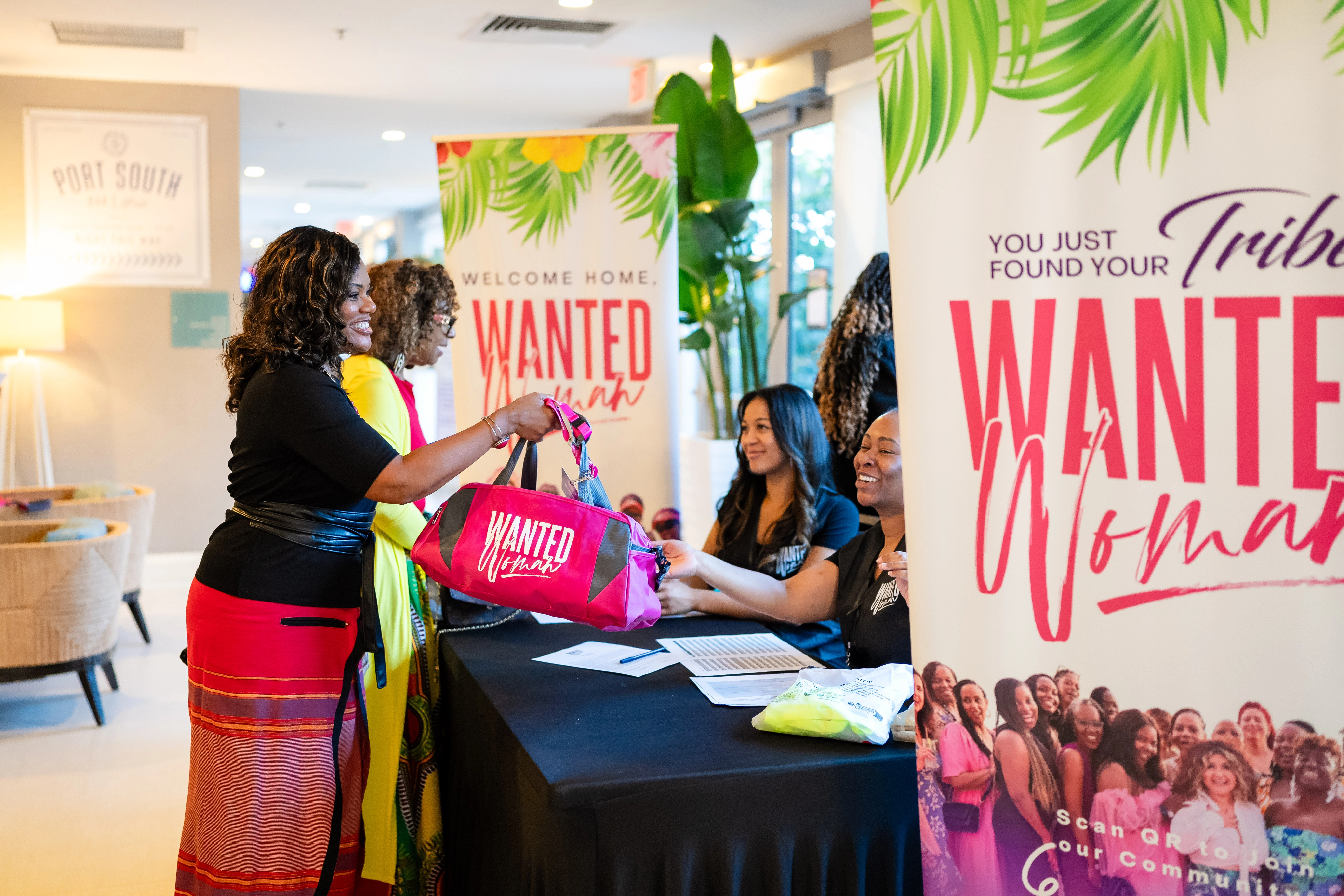 women checking in at WANTED Woman Live event registration table