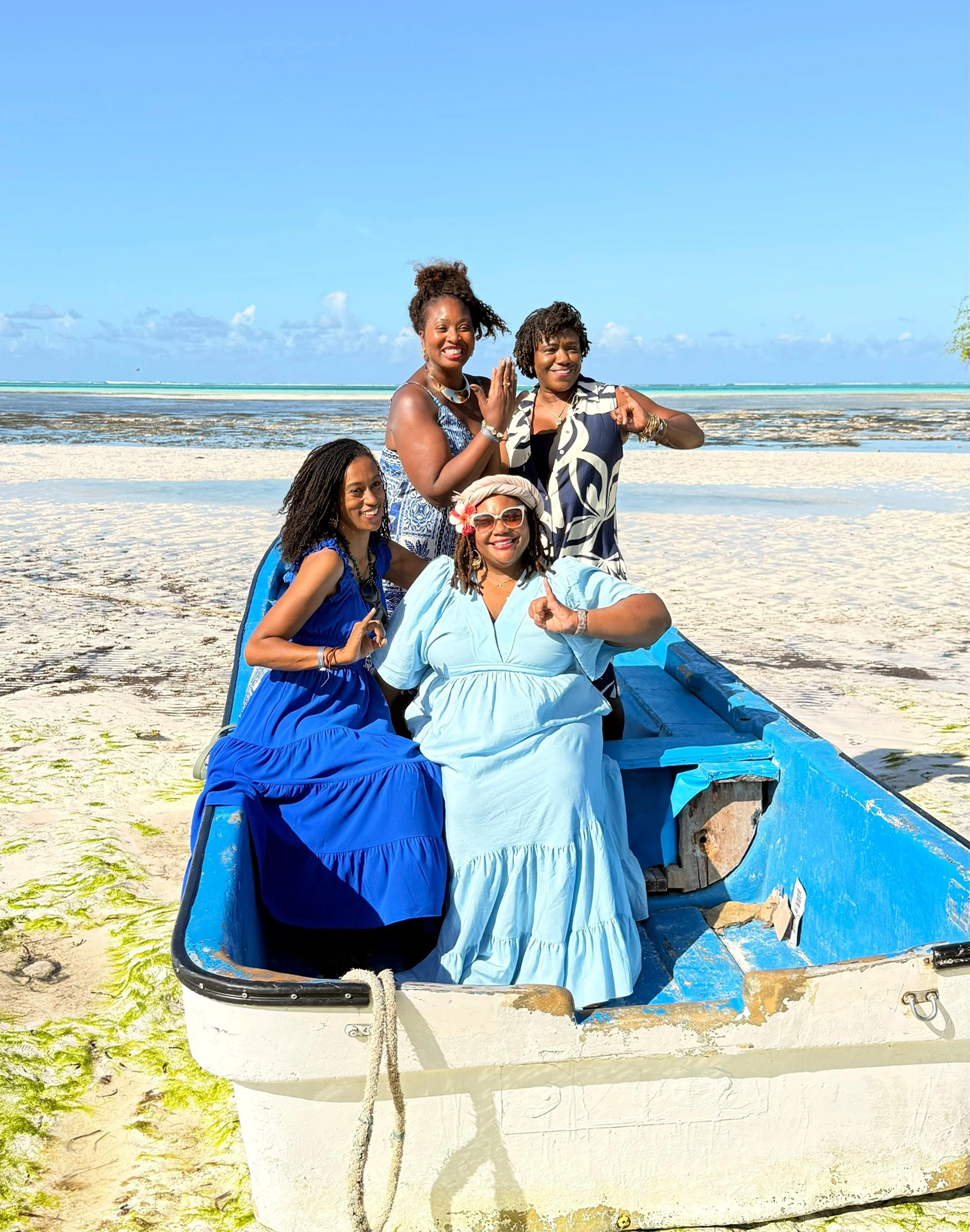 women sitting on boat in Zanzibar beach enjoying luxury retreat experience