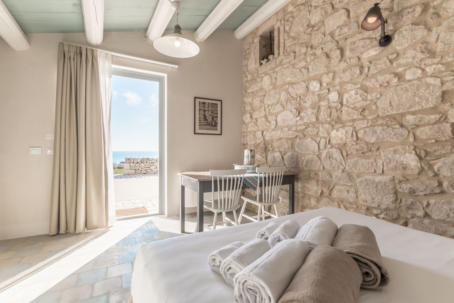 A bright room with its own door opening towards the sea