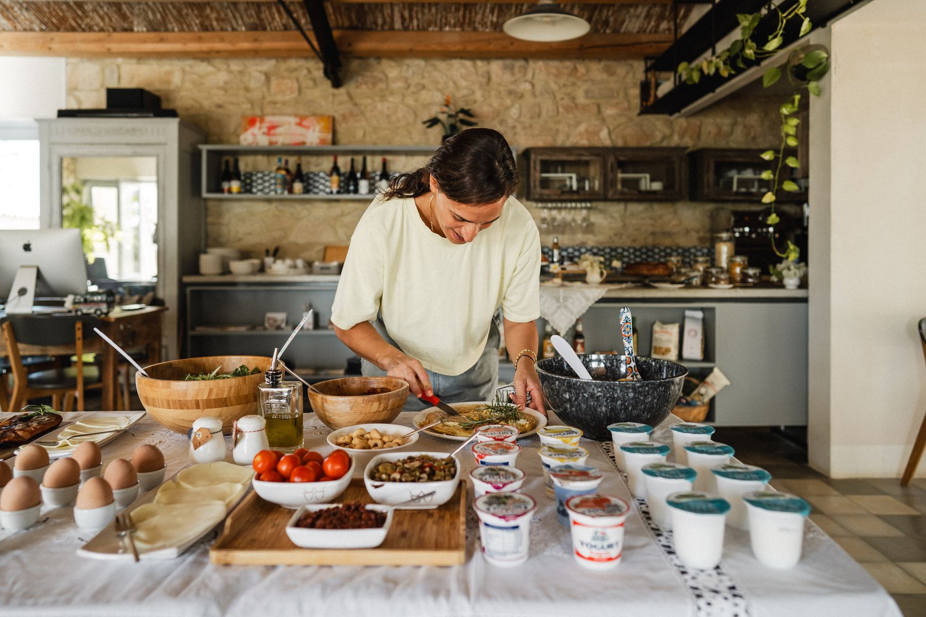 The cook preparing a brunch spread in the farmhouse kitchen