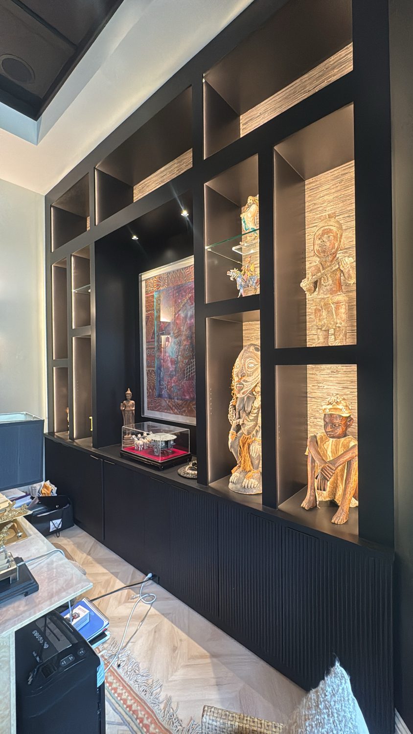 Oak slat media wall with floating cabinetry and lit display niches