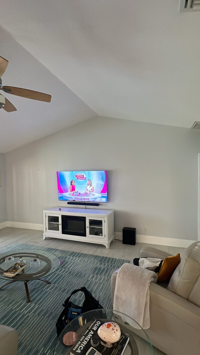 Custom black home office built-in with backlit display bays and fluted cabinet fronts