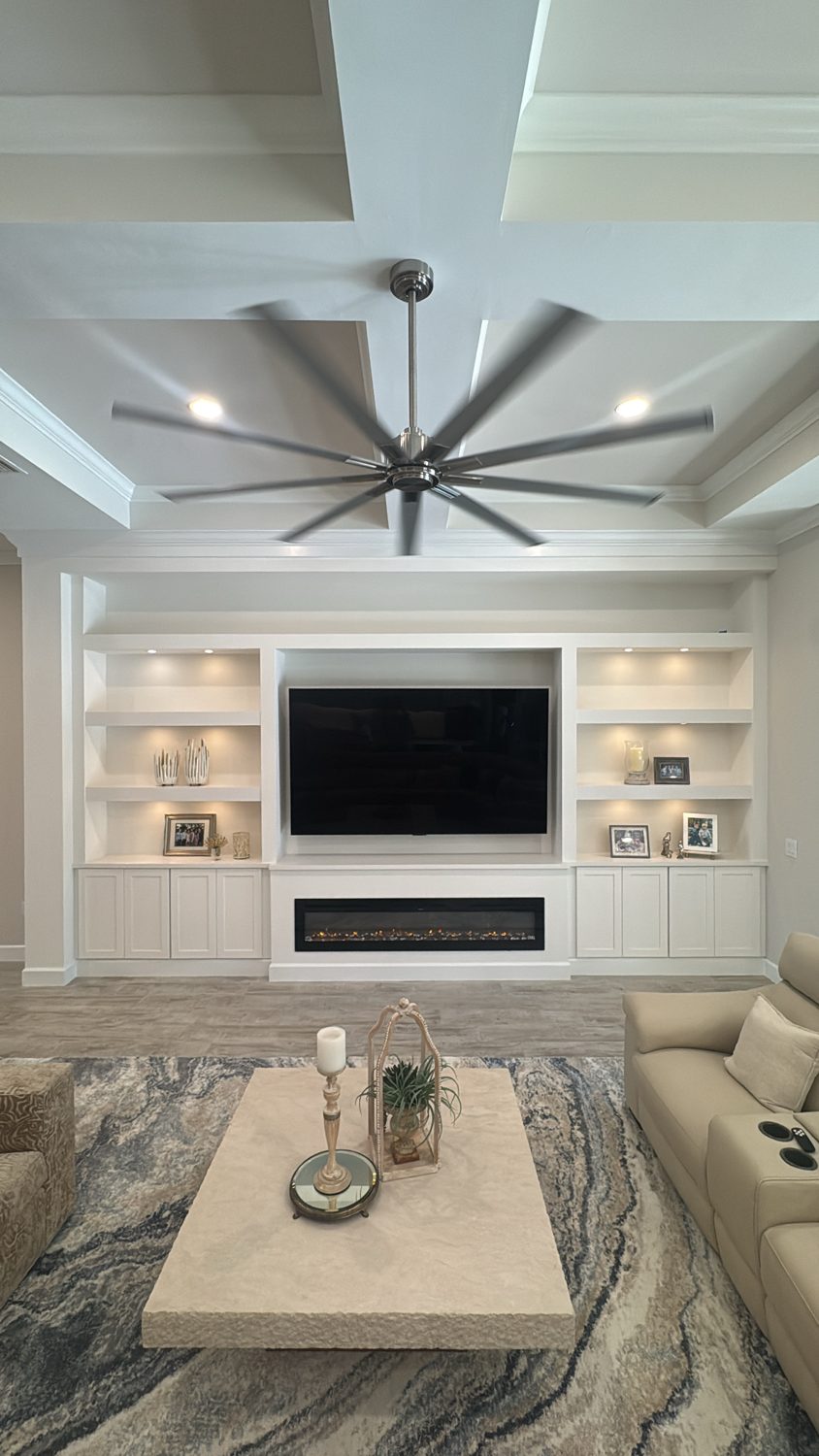 Before &mdash; a blank vaulted living room wall with a television on a console