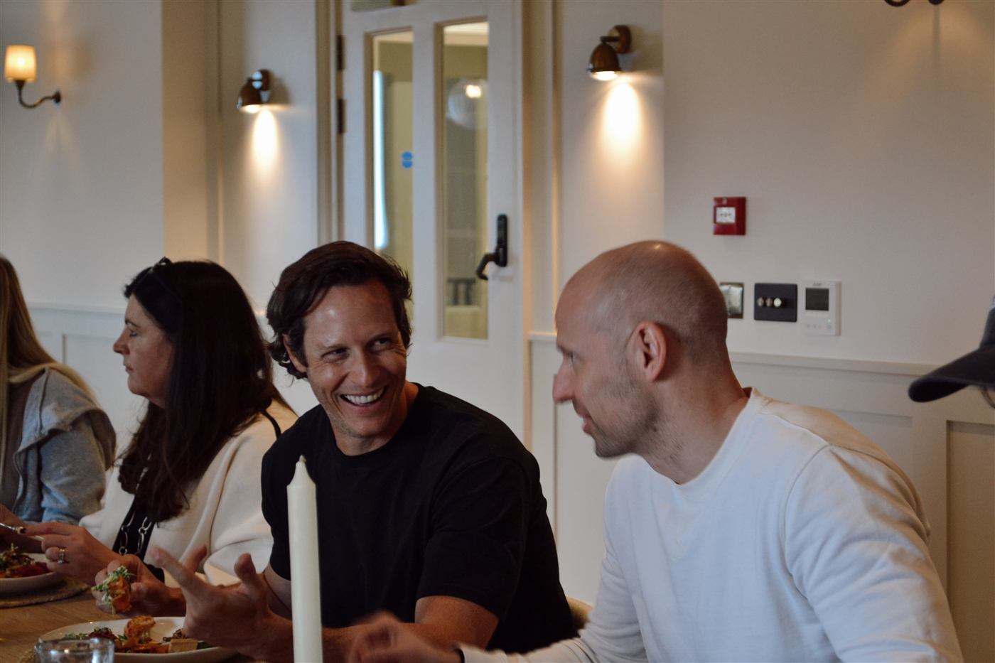 Founders laughing together around a dinner table