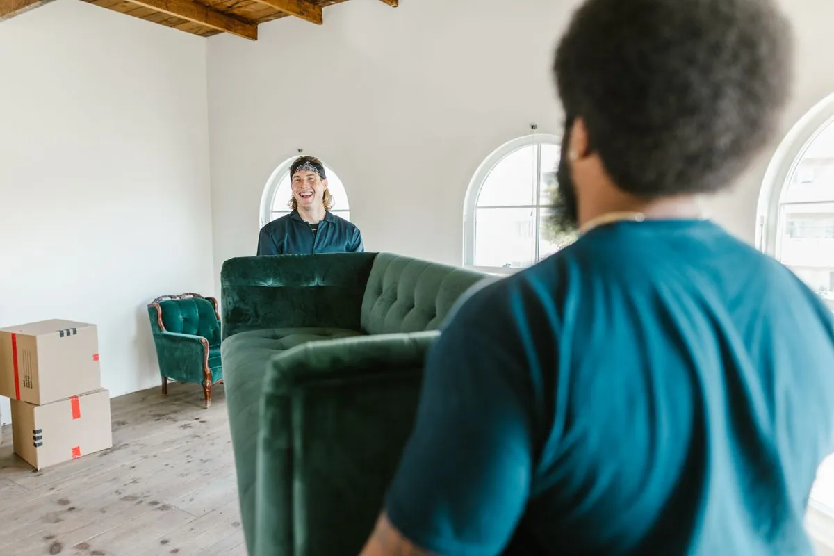 Professional movers carrying a couch
