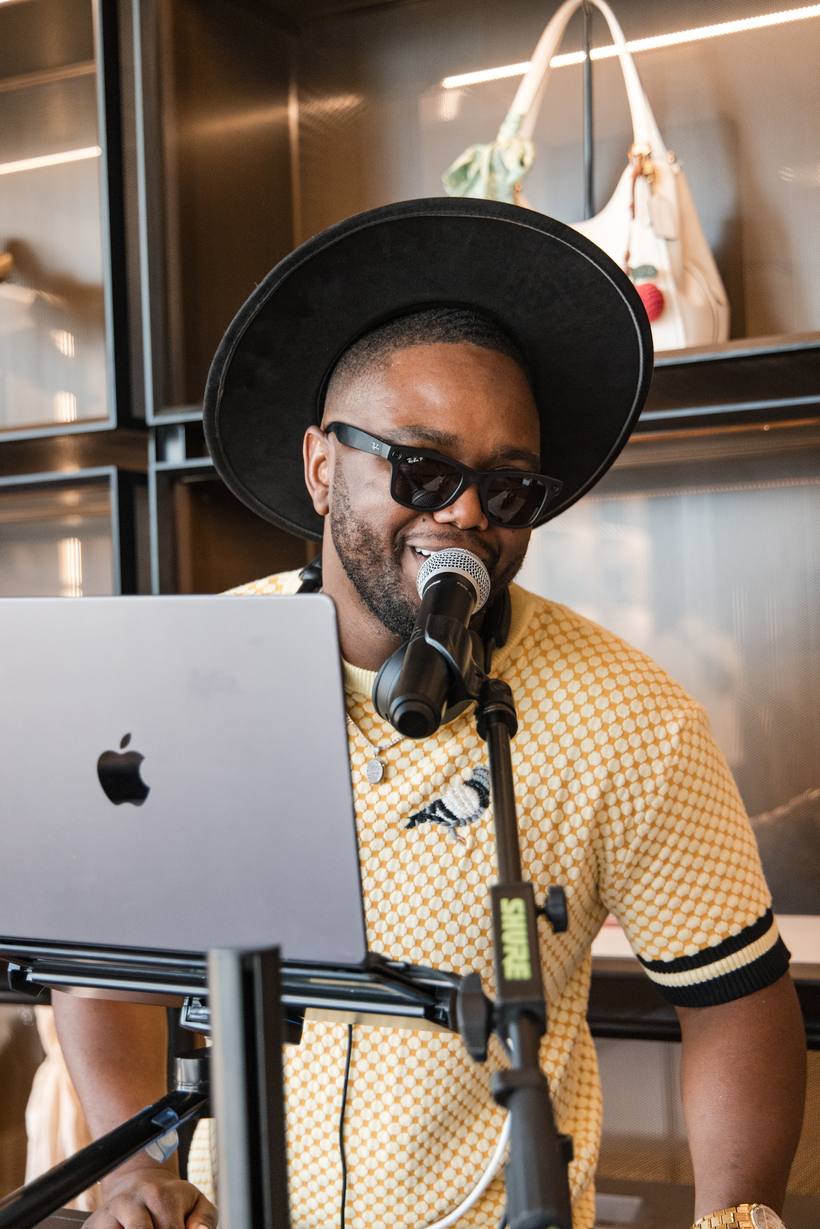 DJ Dream on the microphone behind his booth, mid-set