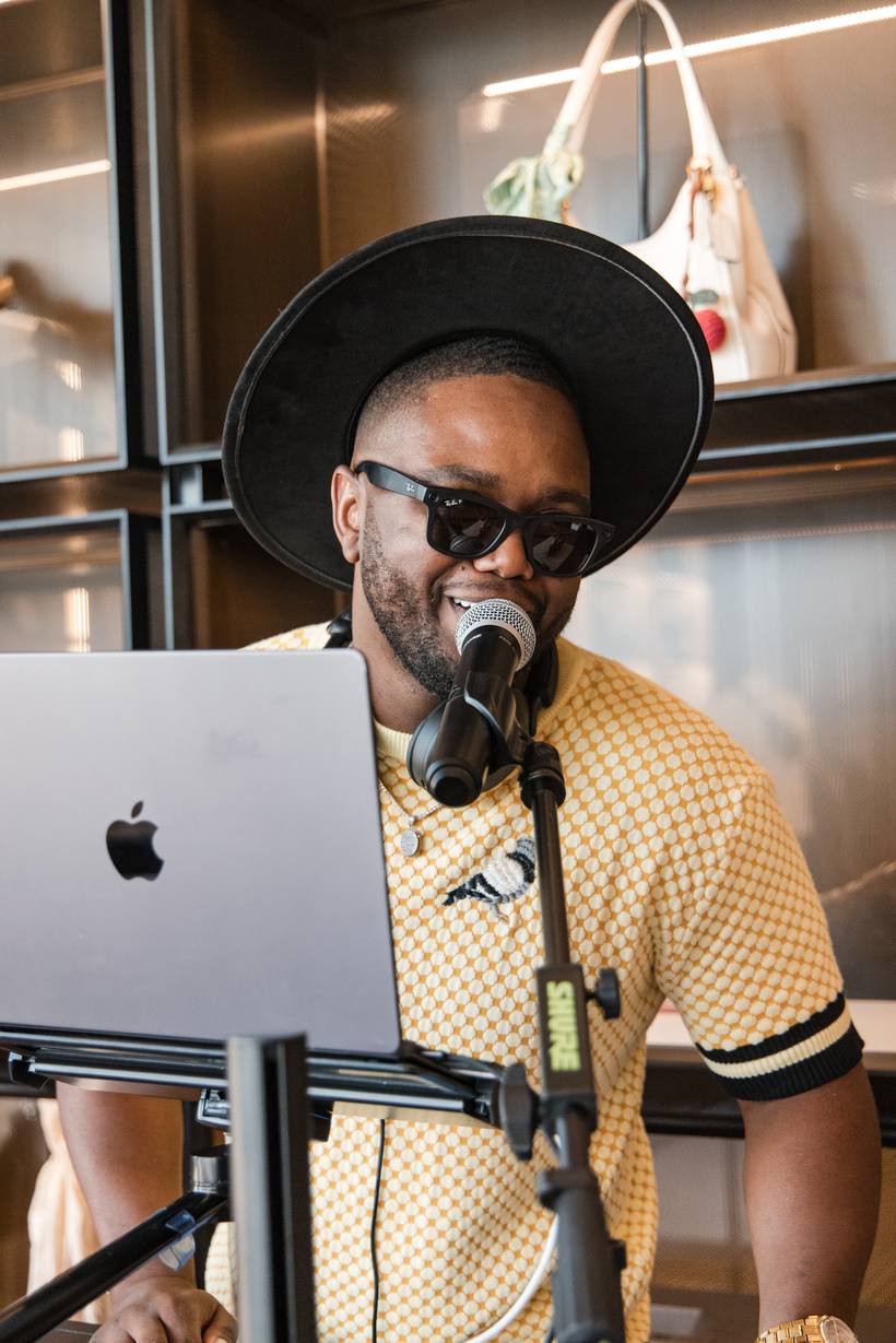 DJ Dream at the booth, singing into the microphone