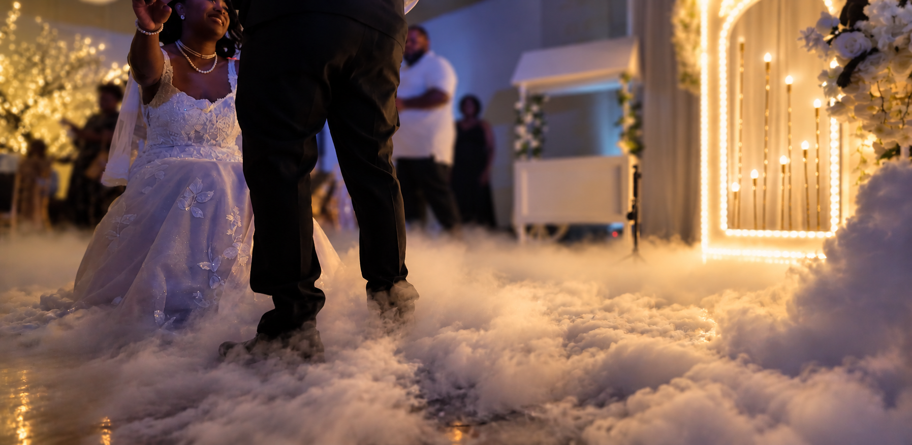 Bride and groom dancing on a floor covered in low cloud