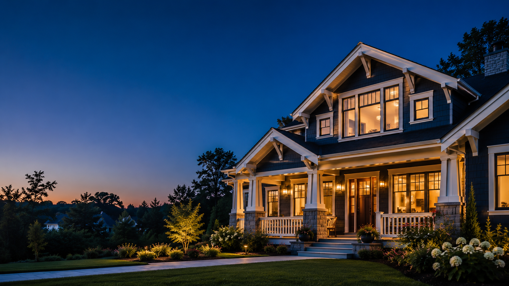 Freshly painted luxury Craftsman home exterior at blue hour with warm interior lighting and immaculate finishes in Liberty, MO