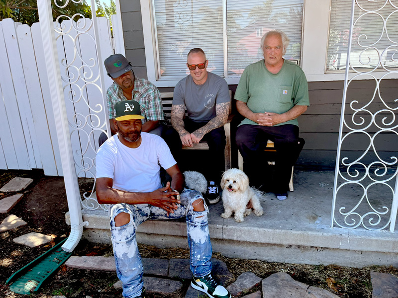 four men and a dog sitting on the porch of the residential treatment home of Retraining the Village nonprofit it east Palo Alto California four men and a dog sitting on the porch of the residential treatment home of Retraining the Village nonprofit it east Palo Alto California