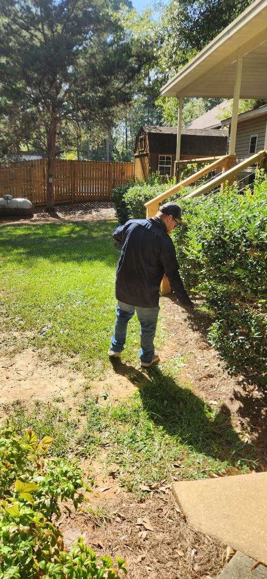 Termite control technician inspecting the foundation of a Central Alabama home for termite activity