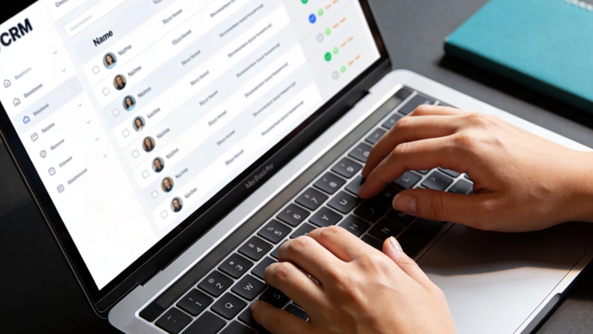 Hands on laptop showing CRM dashboard - automated business processes for small business owners