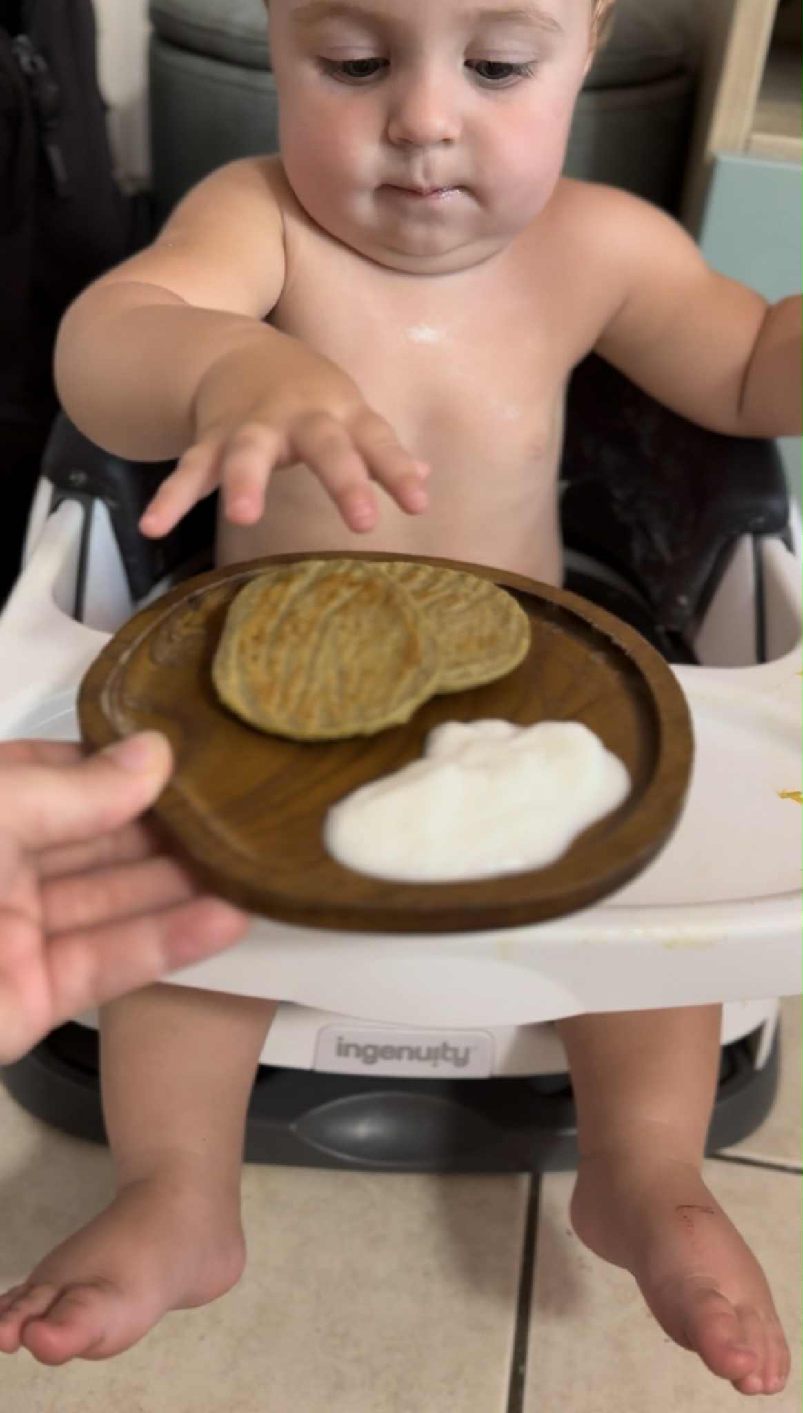 Baby happily eating real food