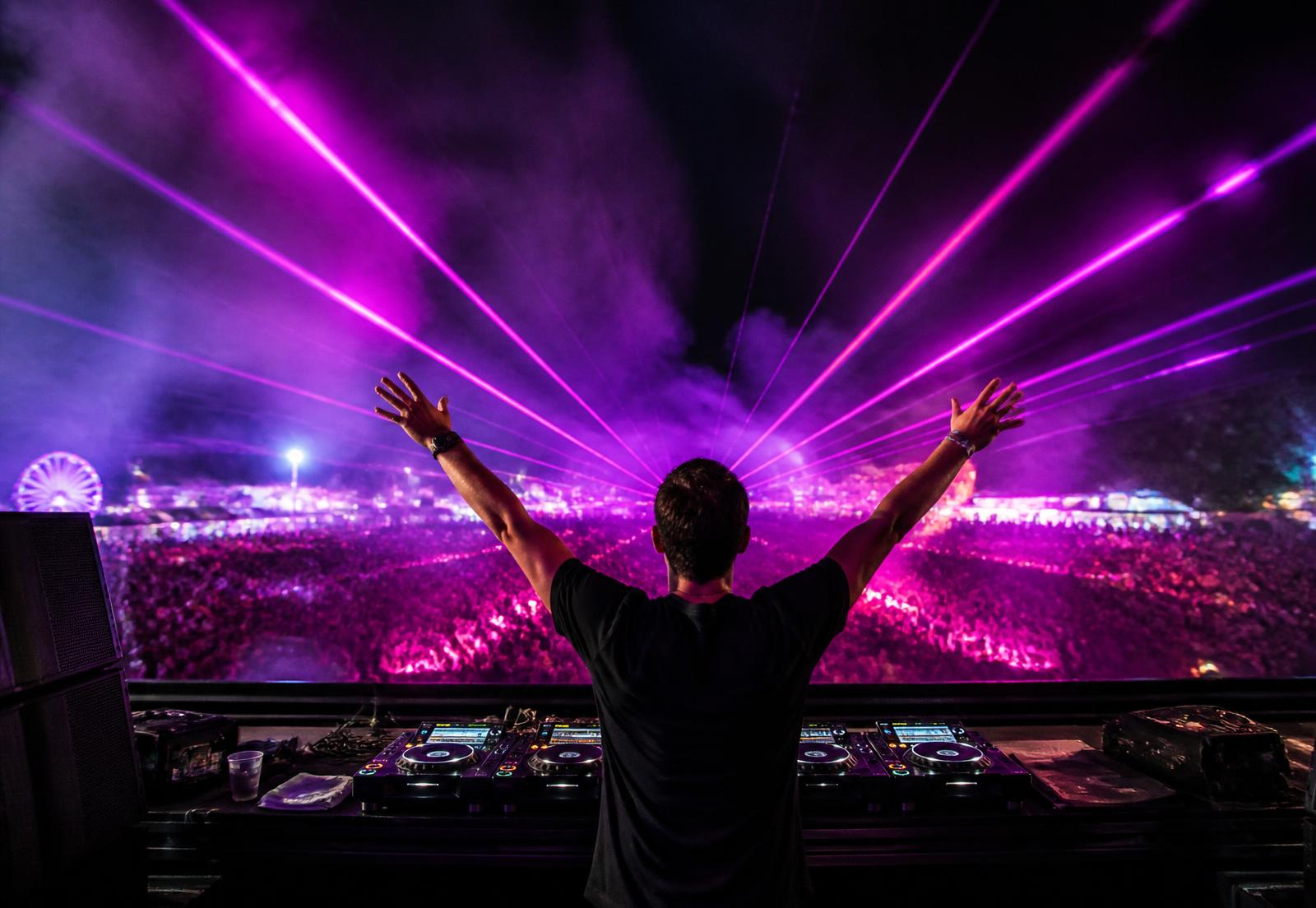 DJ performing under neon lasers