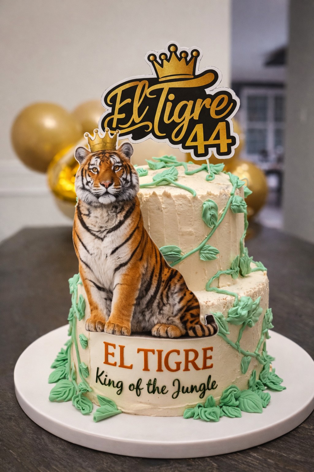 Custom El Tigre jungle-themed birthday cake with tiger topper, gold crown decorations, and buttercream vines by Mariposas. Custom El Tigre jungle-themed birthday cake with tiger topper, gold crown decorations, and buttercream vines by Mariposas.
