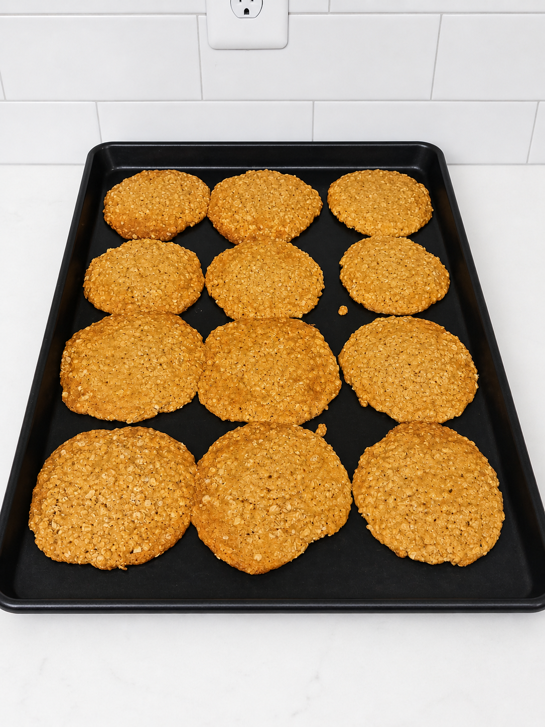 “Homemade oatmeal cookies baked fresh on a tray in a clean kitchen setting”