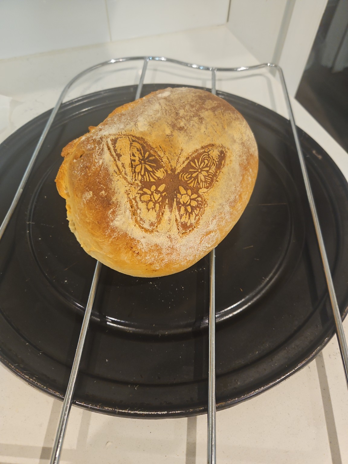 “Homemade rustic farmhouse bread loaf with butterfly design baked using whey from homemade cheese” “Homemade rustic farmhouse bread loaf with butterfly design baked using whey from homemade cheese”