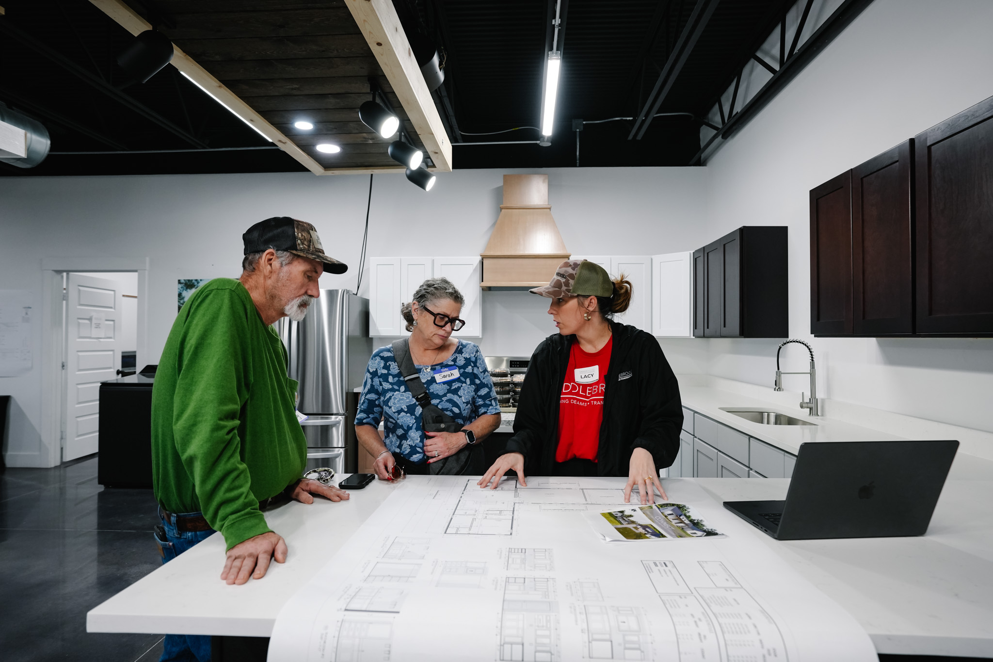 Saddlebrooke team member reviewing floor plans and financing with a couple