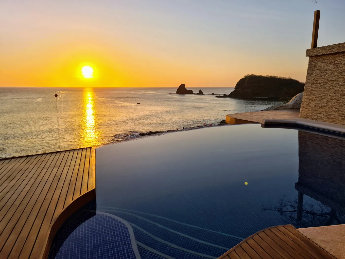 Infinity pool at sunset, Maderas Rock in the bay, Villas Playa Maderas, Nicaragua
