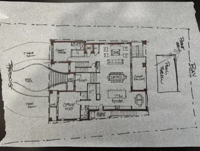 A hand-drawn floor plan sketch on tracing paper