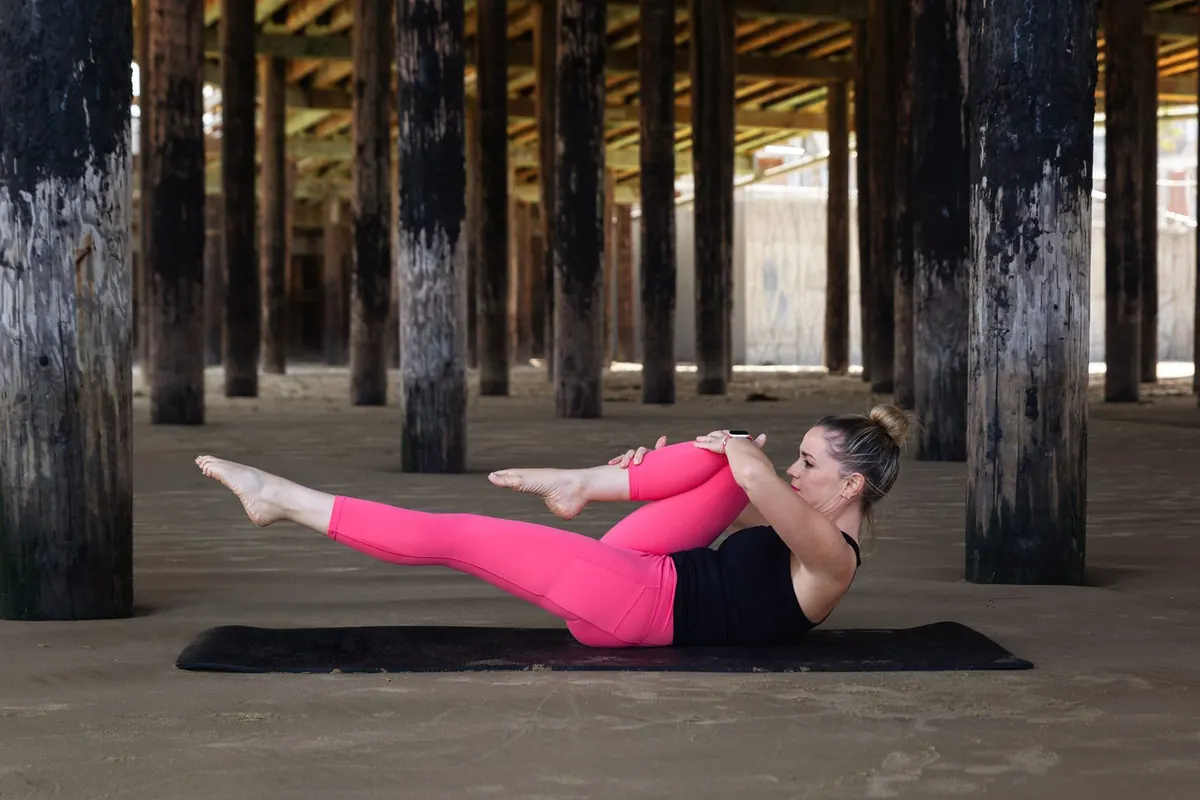Anya Gossage doing a Pilates core exercise on a mat