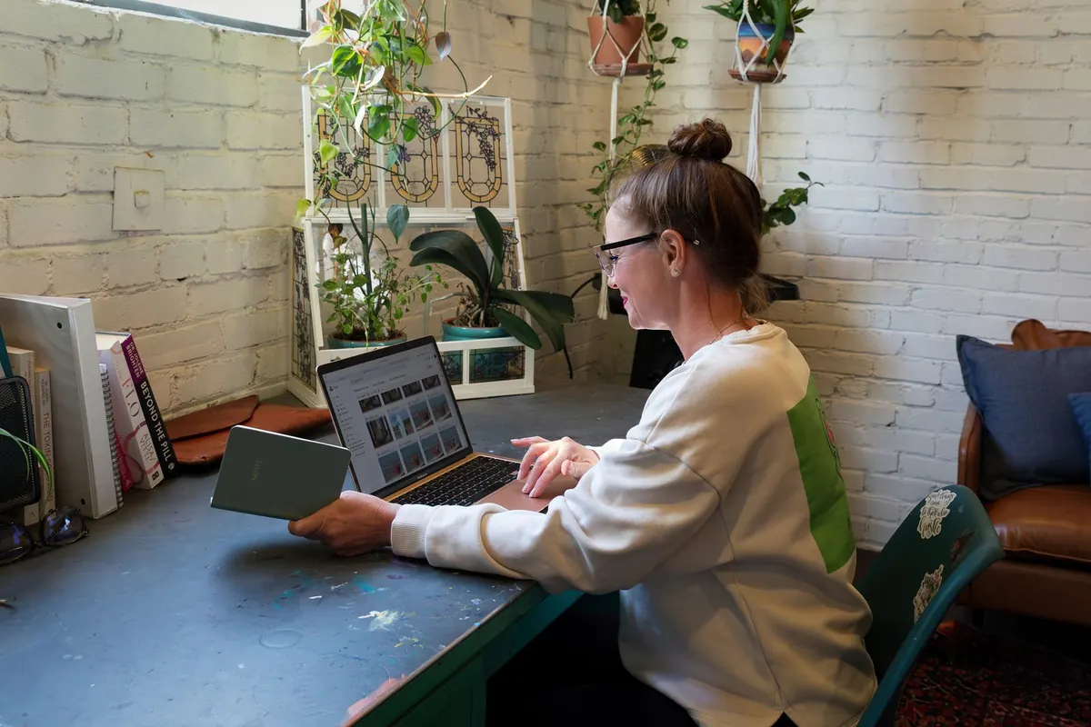 Woman watching a wellness lesson on her laptop at home