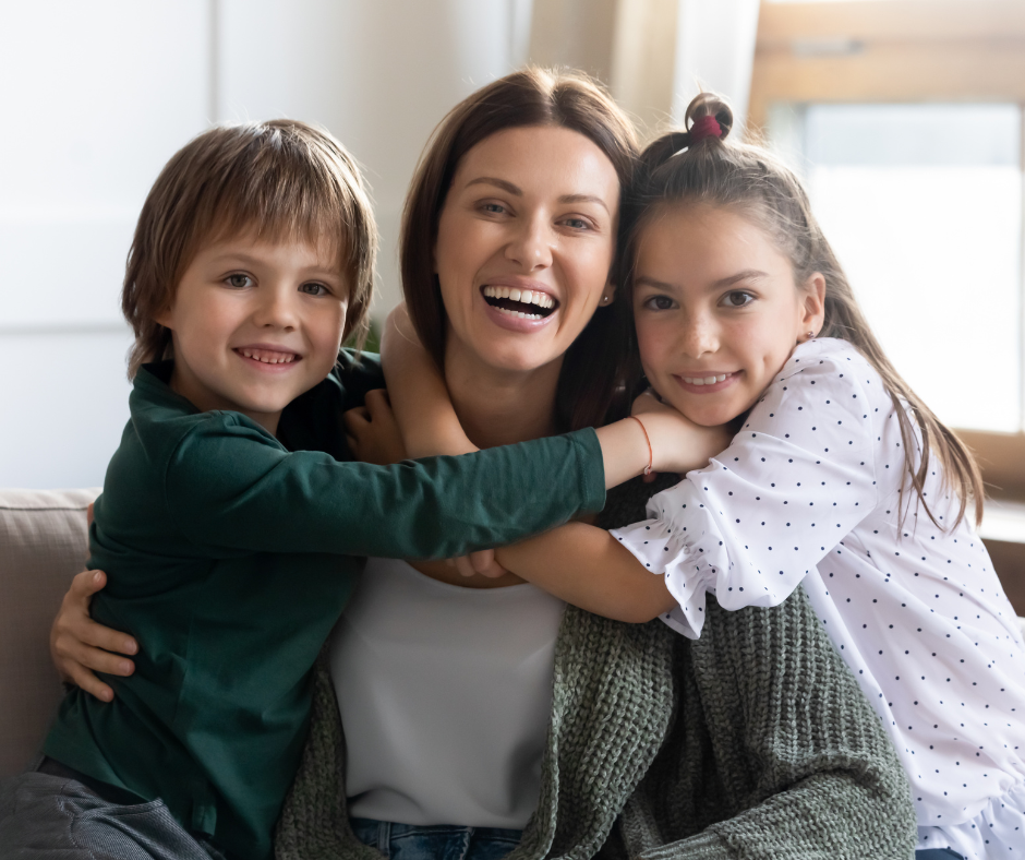 Mother hugging her son and daughter