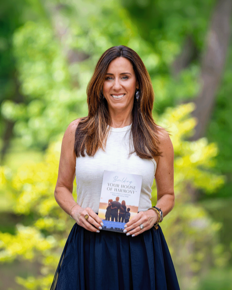 Deborah Winters holding her book, Building Your House of Harmony
