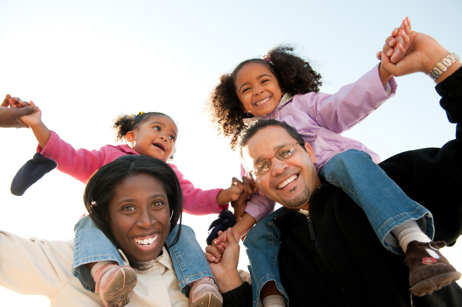 Black family playing together outdoors