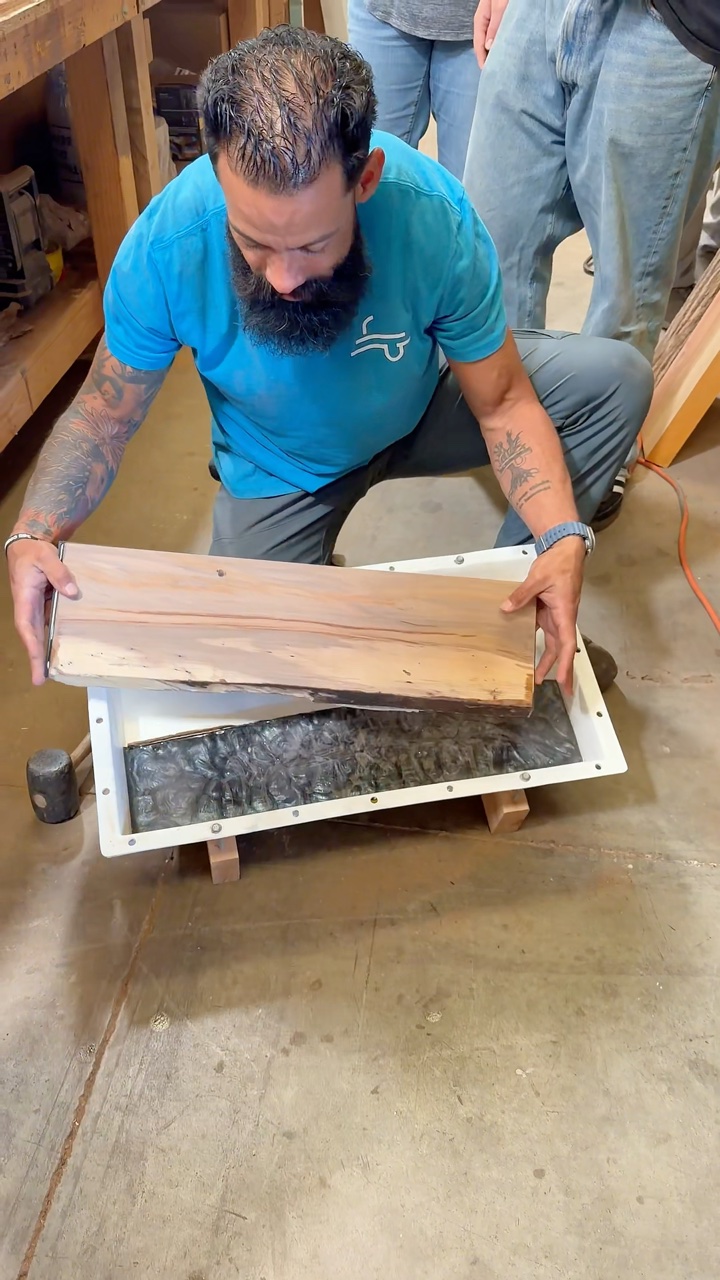 Woodworker lifting a slab