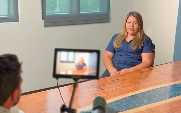 Filming an interview with a client's team member at their office