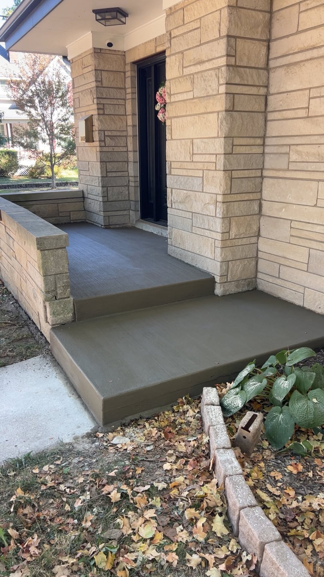 Newly poured front porch and stairs after replacement by JW Concrete Construction