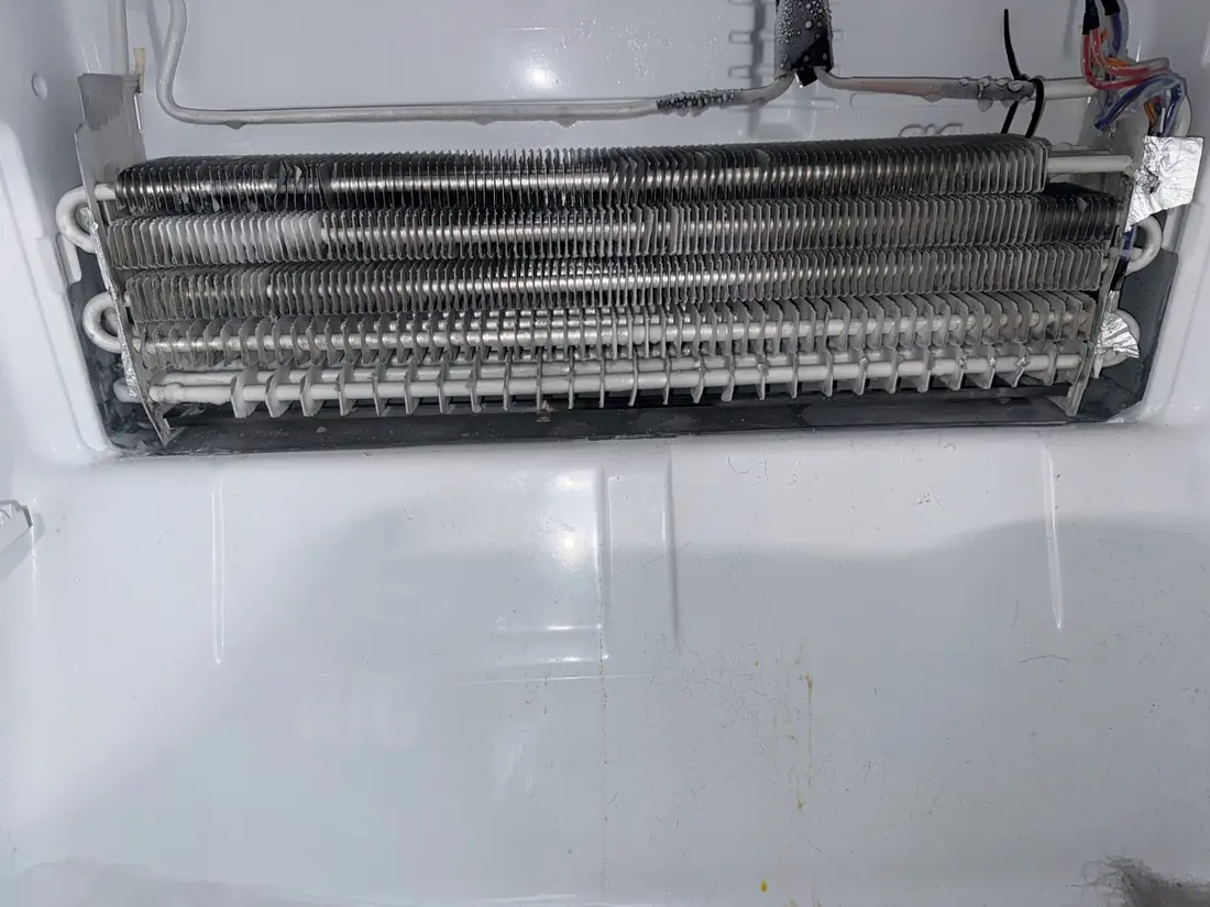 Refrigerator evaporator coil thawed and exposed for testing