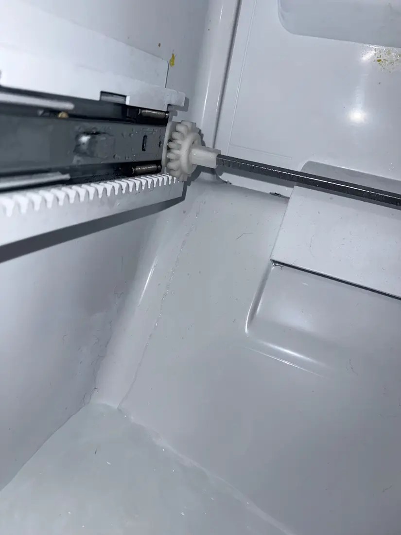 Thick sheet of ice built up on the floor of a freezer compartment