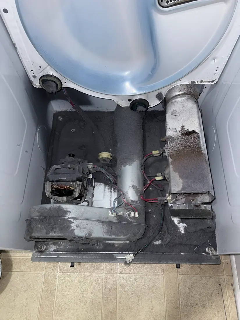 Dryer interior packed with lint around the motor and blower