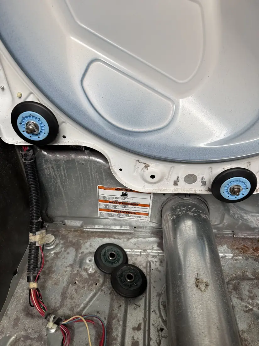 New dryer drum support rollers installed, with the worn old rollers below