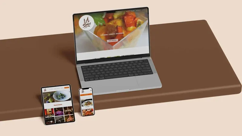 A catering company's website on a laptop, tablet and phone