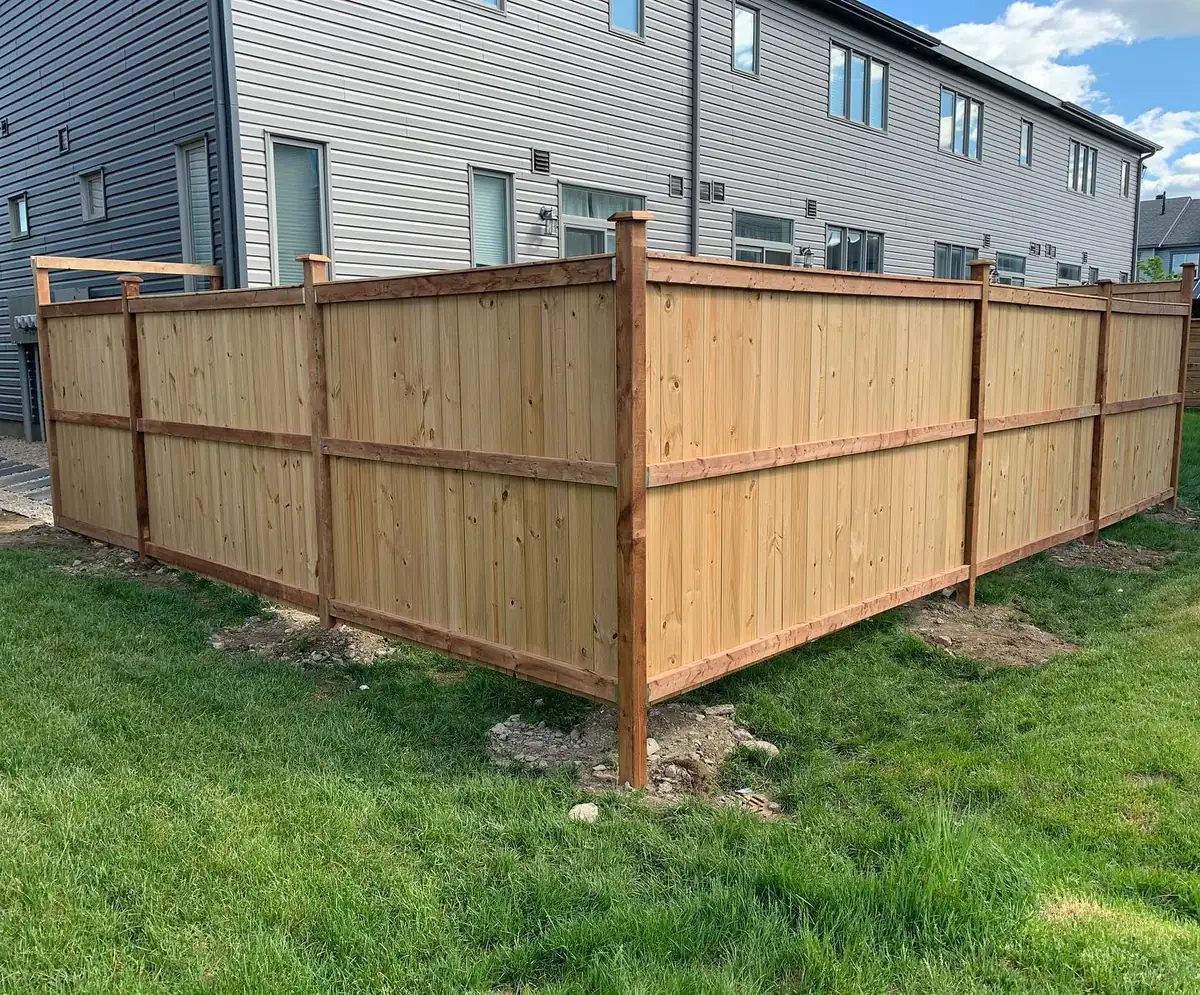 A new wood privacy fence around a townhouse backyard, built by Backyard Pros