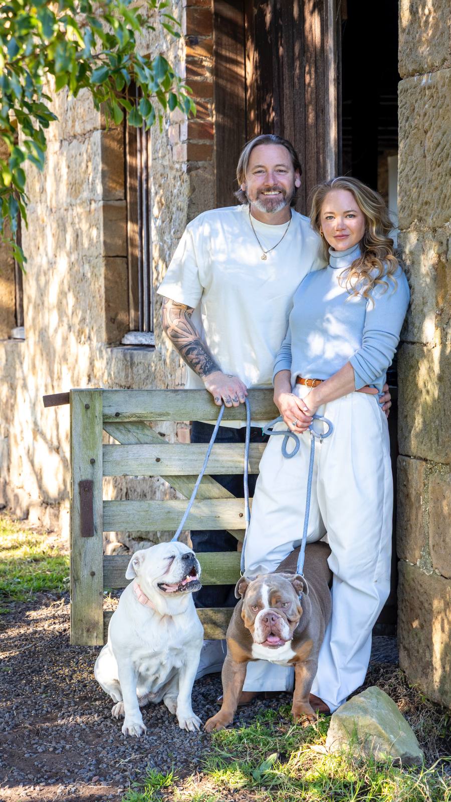 Michaela Sparrow and her husband Peter at home with their rescue bulldogs Rose and Otis