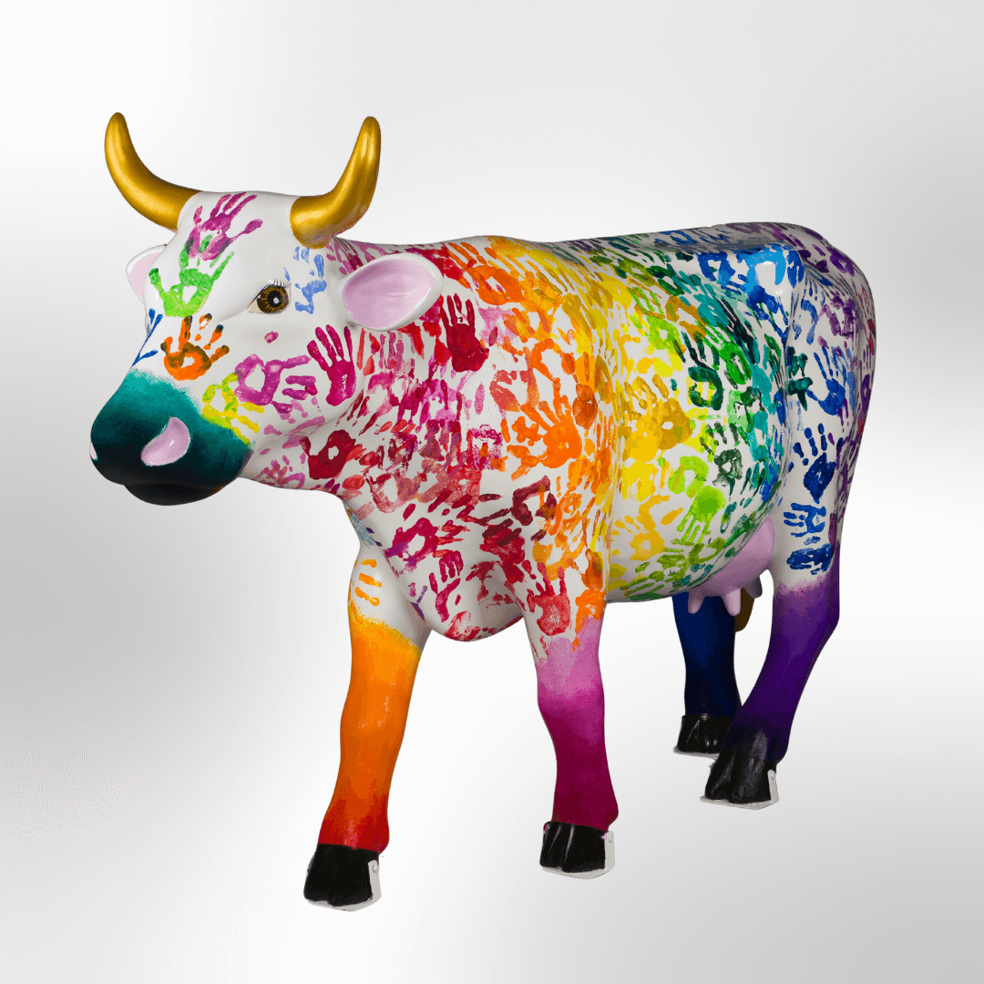 A cow covered in colorful handprints