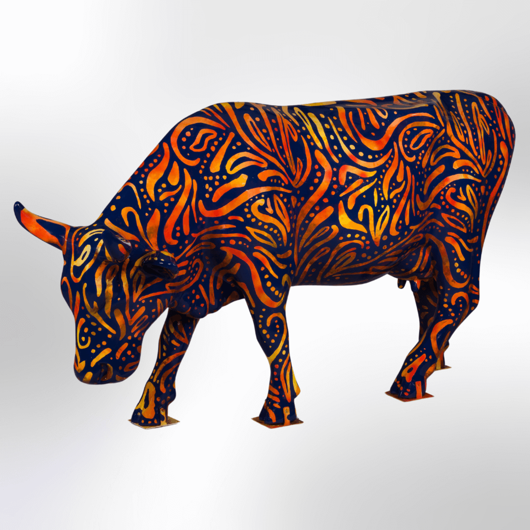 A dark cow covered in a bright abstract batik design all over