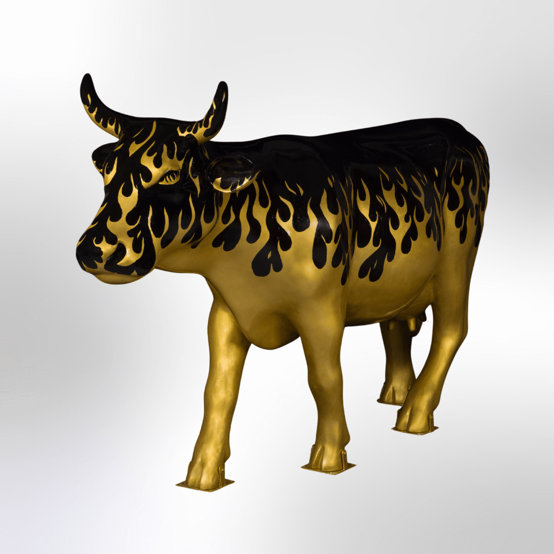 A cow half covered in golden flames