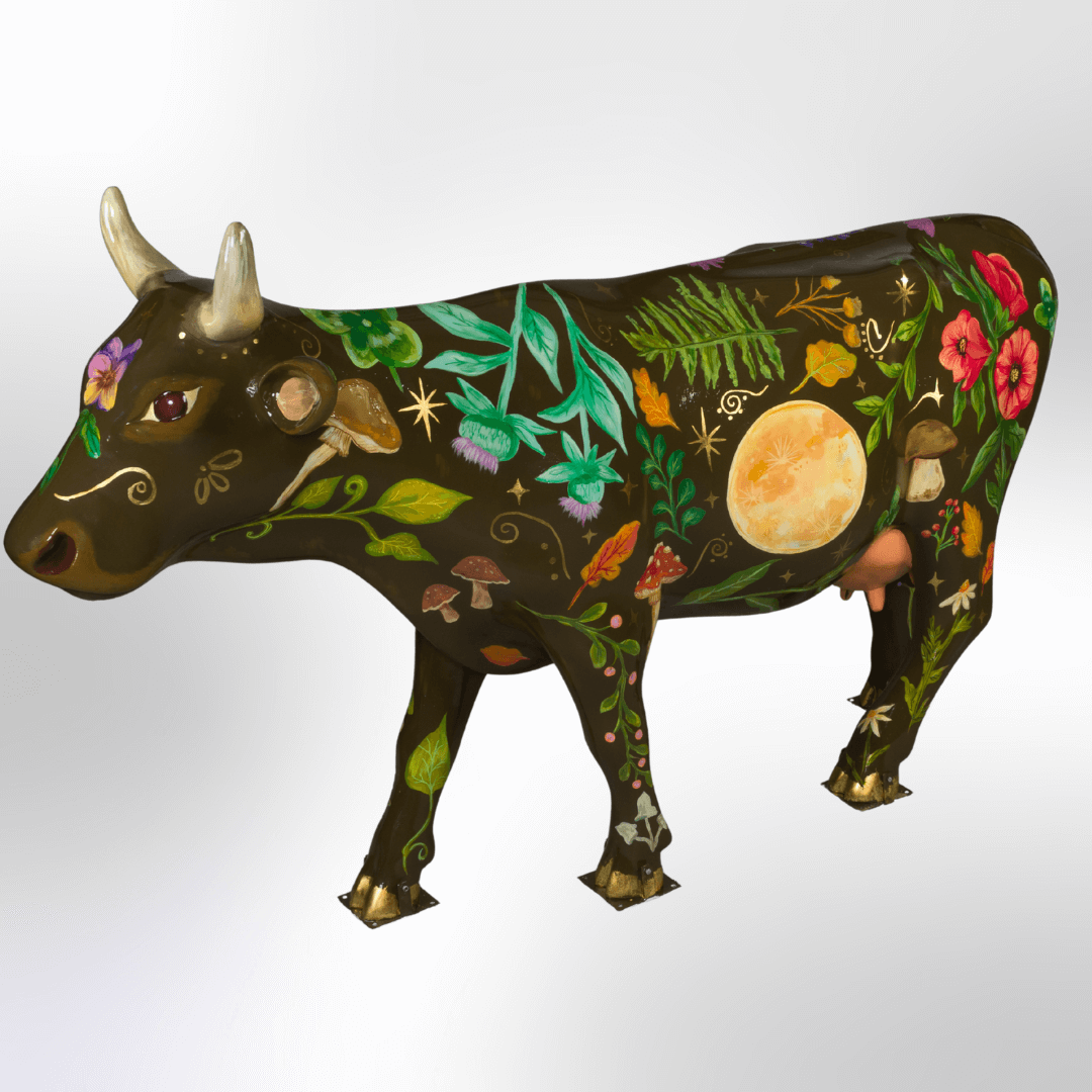 A black cow covered in a moon, mushrooms, leaves, flowers, and stars