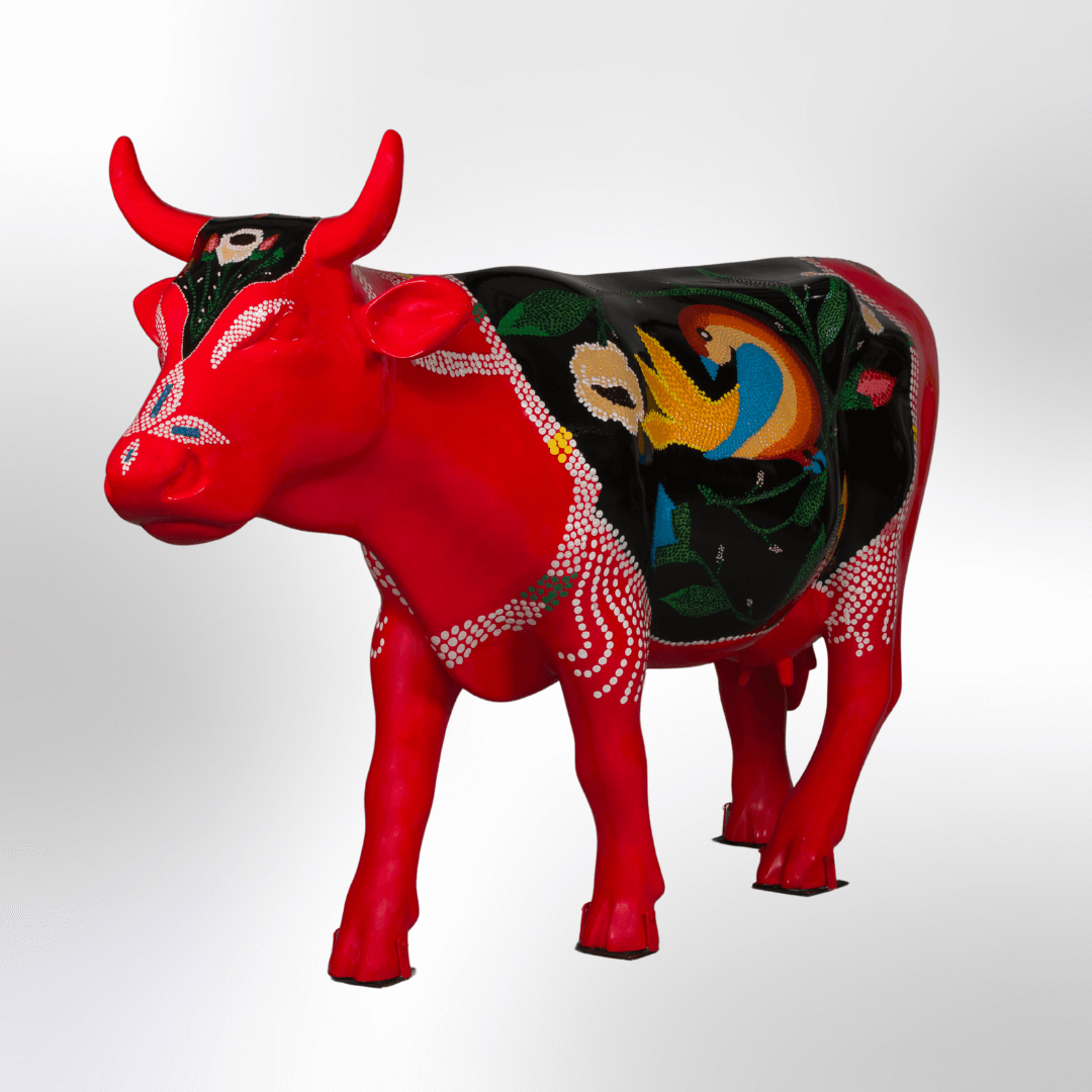 A bright cow covered in a folk art motif mimicking a beaded purse