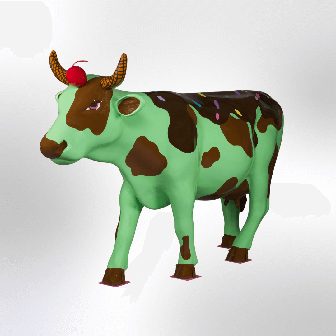 A cow decorated like a mint chocolate chip ice cream sundae, complete with horns that look like waffle cones and a cherry on its forehead