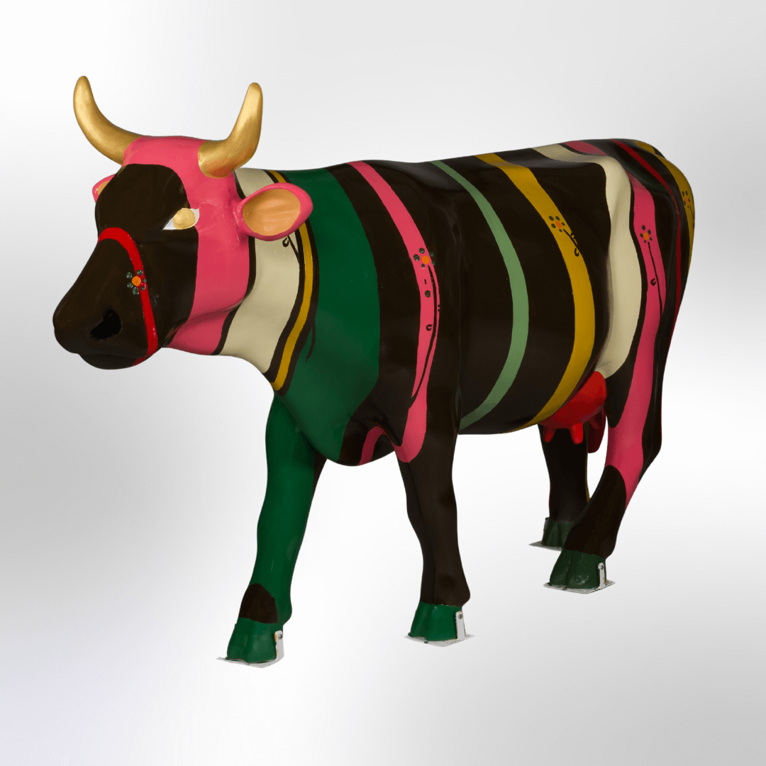 A cow sculture painted either colorful strives and flowers