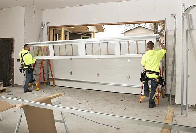 Blue Hen team installing garage door